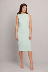 A woman modeling a sleeveless, bodycon midi dress in a pale mint green color, paired with strappy high-heeled sandals, against a neutral gray studio background.