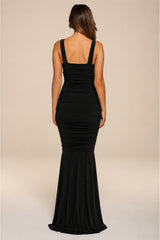 Black evening gown on a beige background
