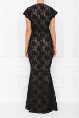 A maxi dress with black lace fabric, featuring cap sleeves and a pleated front, with an invisible zip and nude underline.
