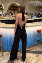 SASHA BLACK BACKLESS JUMPSUIT WITH WIDE LEGS AND GOLD LEAF TRIM